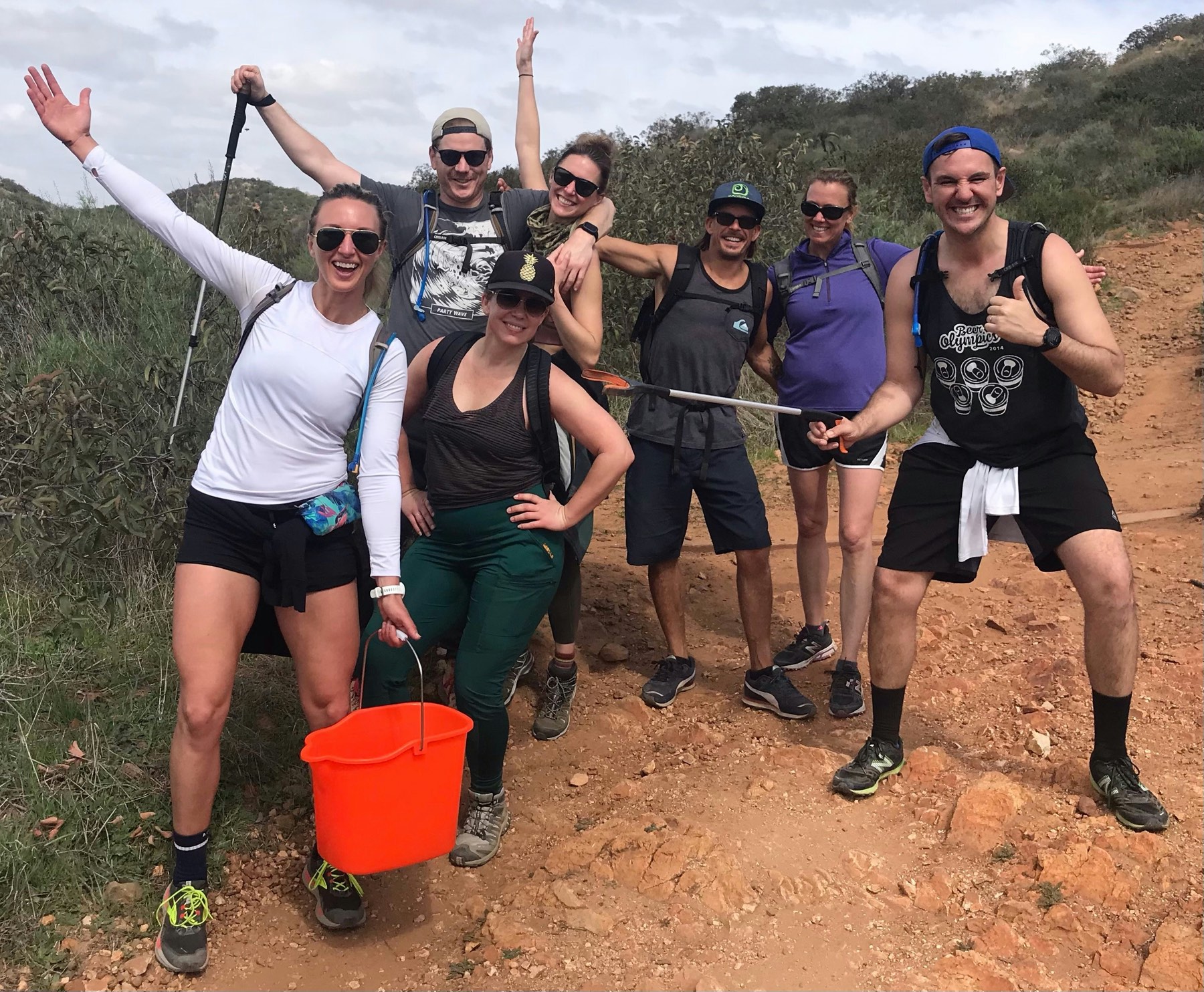 A group of volunteers celebrating together outdoors